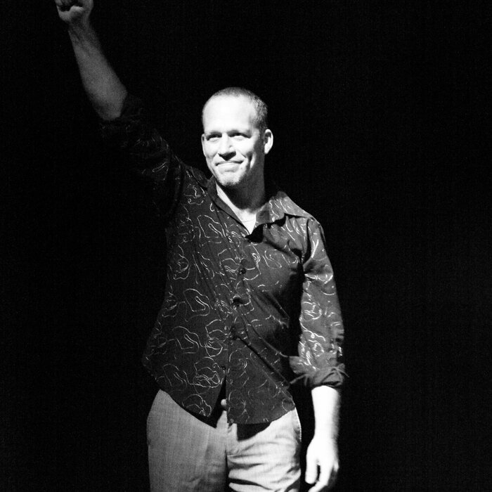 Taking a bow, fist raised, at the end of the concert